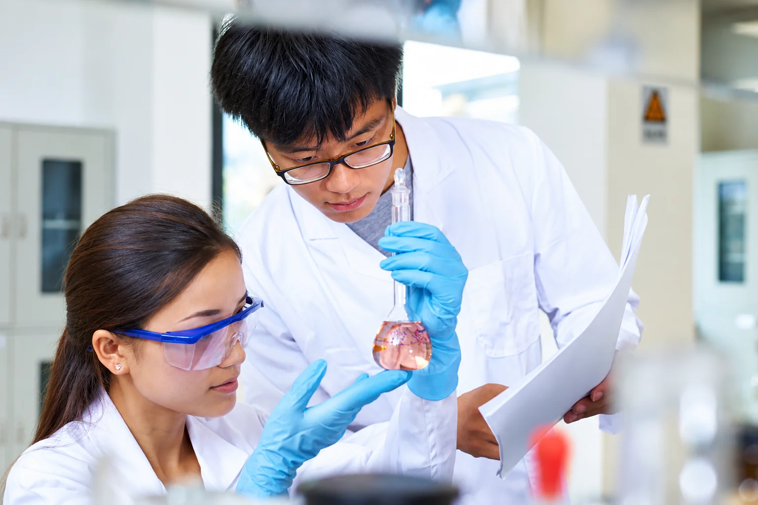 Scientists conducting experiments in a laboratory at Polymics, Ltd.